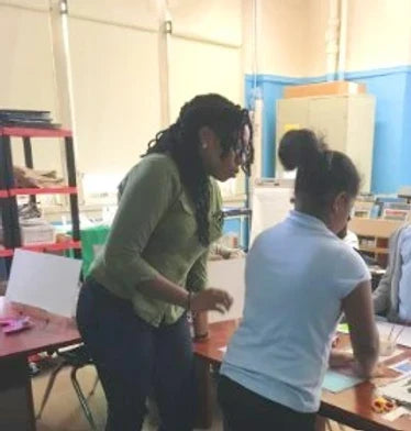 teacher and student standing at craft table