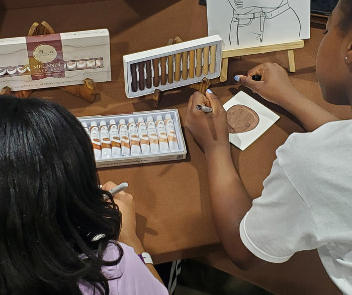 girls creating portraits with inclusive art supplies